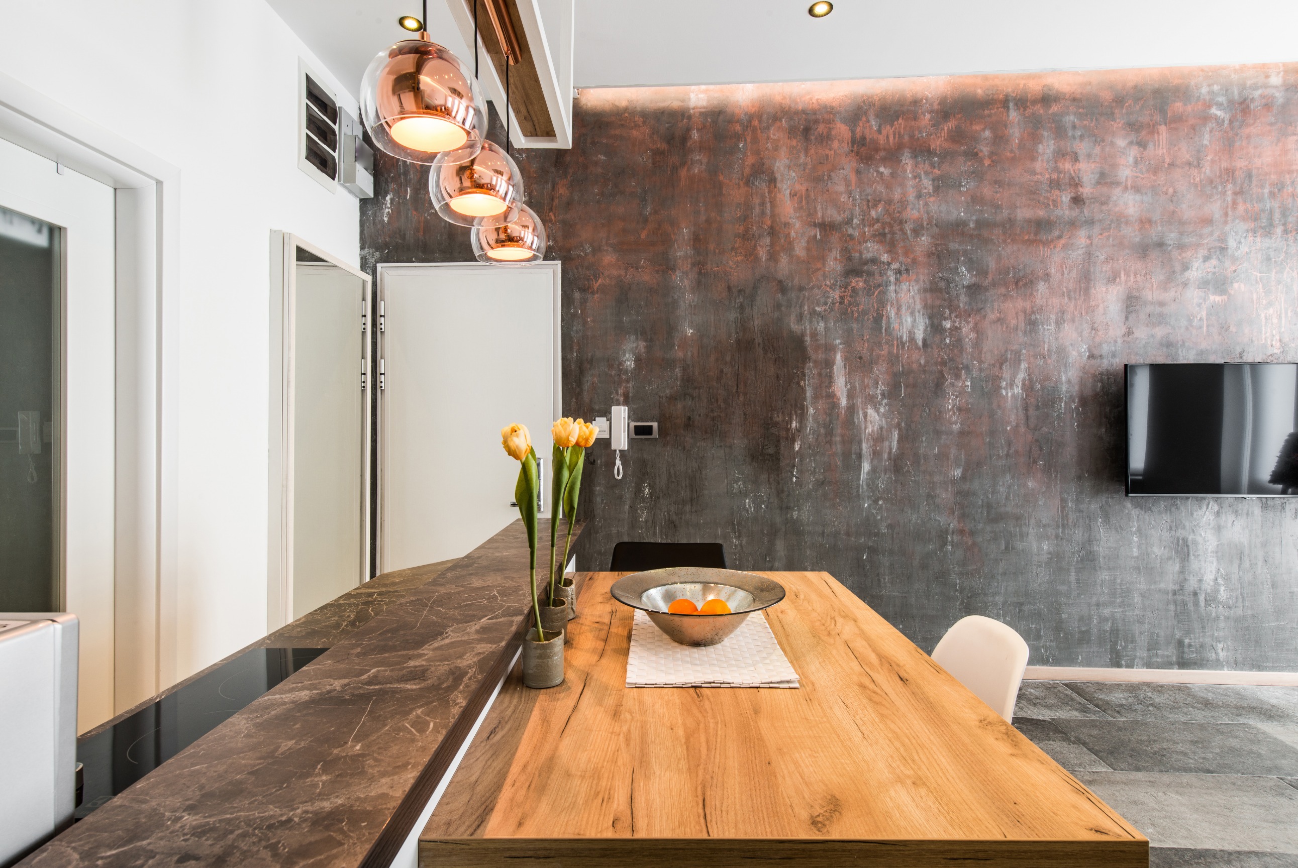 Modern apartment interior with warm lighting and a dining table