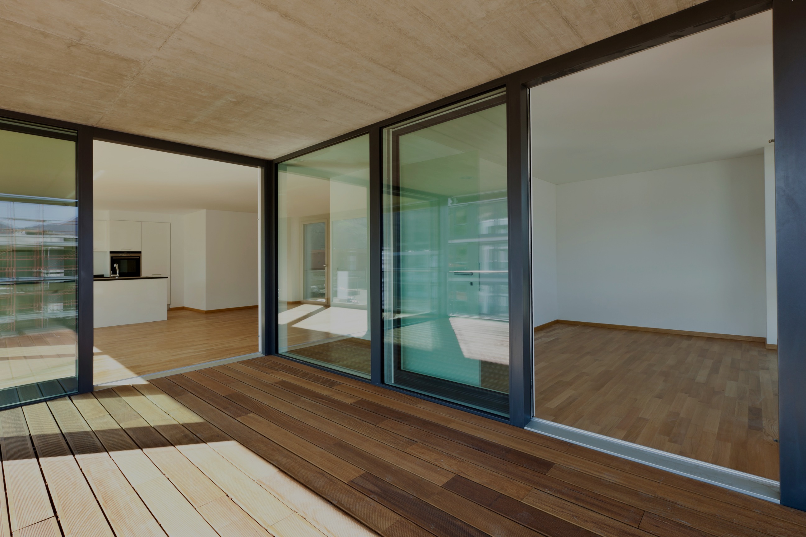 Modern building interior with a wood deck and glass doors